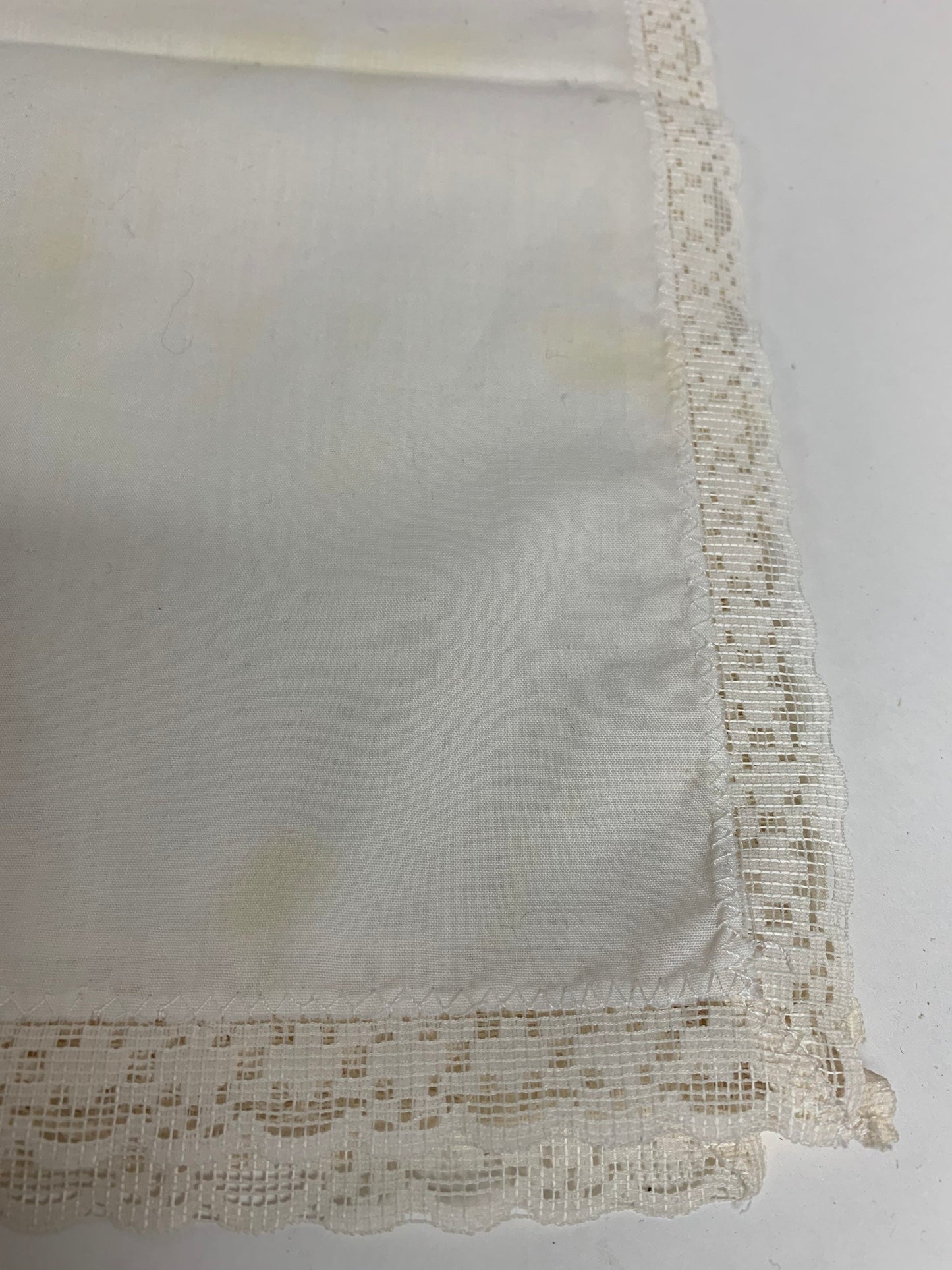 Four ivory cotton and lace dinner napkins