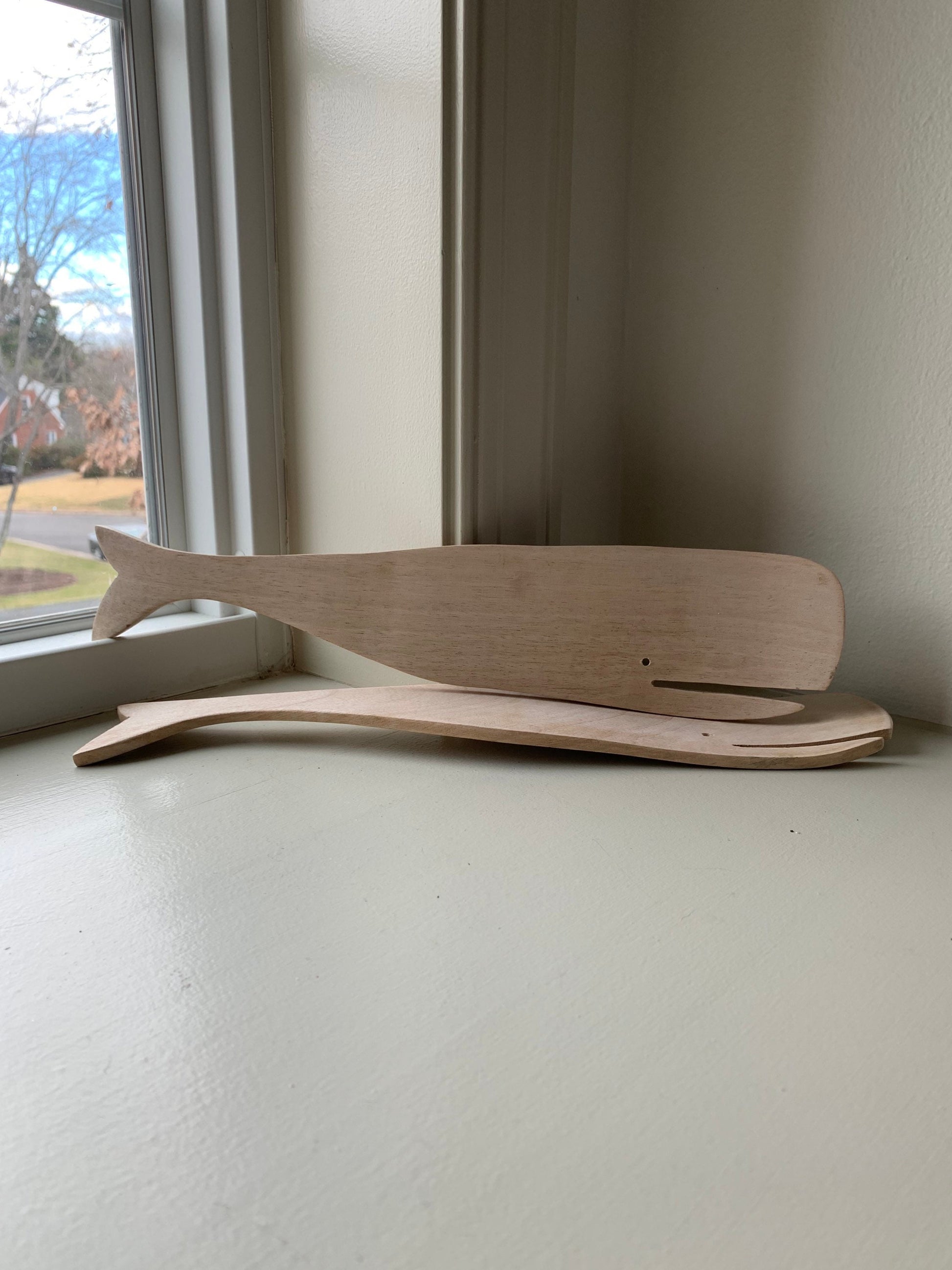 12.5” long wood salad servers in sperm whale shape.